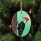 A wood slice with a hand-painted pileated woodpecker available for purchase at Cove Creek Photography.